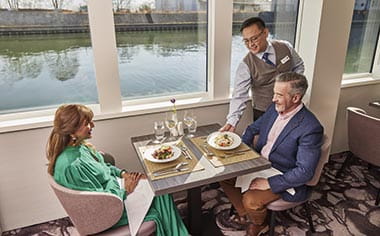A couple enjoying dinner in the Panorama Restaurant on Spirit of the Rhine